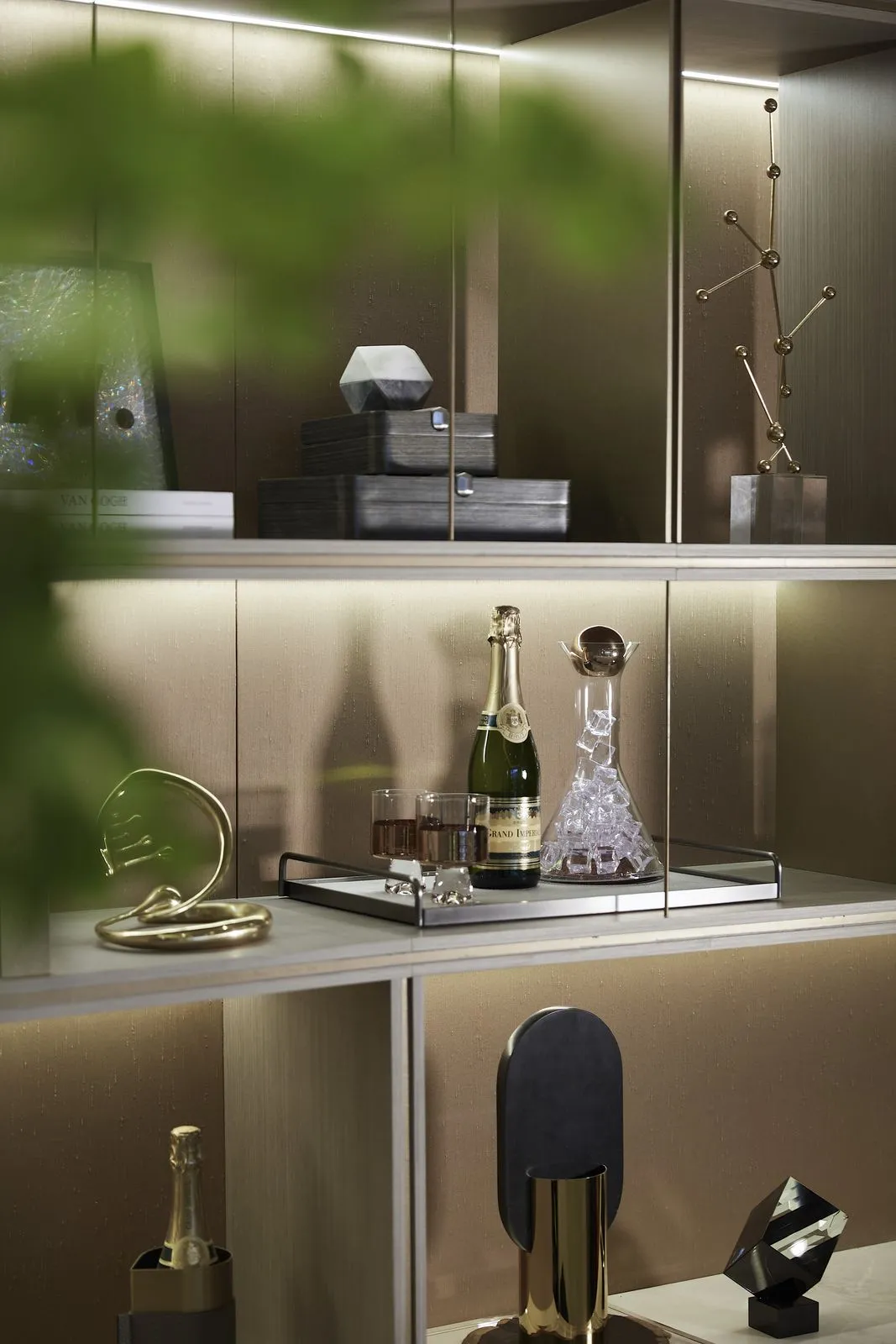 A stylish modern bar display featuring gold accessories and a bottle of champagne.