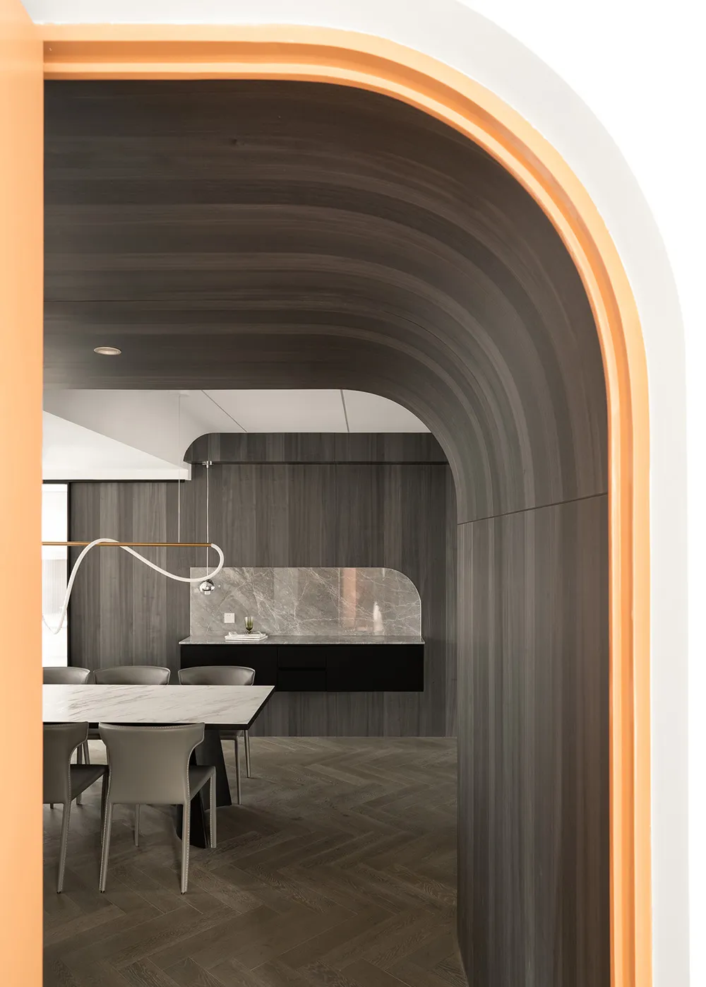 A modern interior space featuring dark wood paneling and a contemporary design aesthetic.