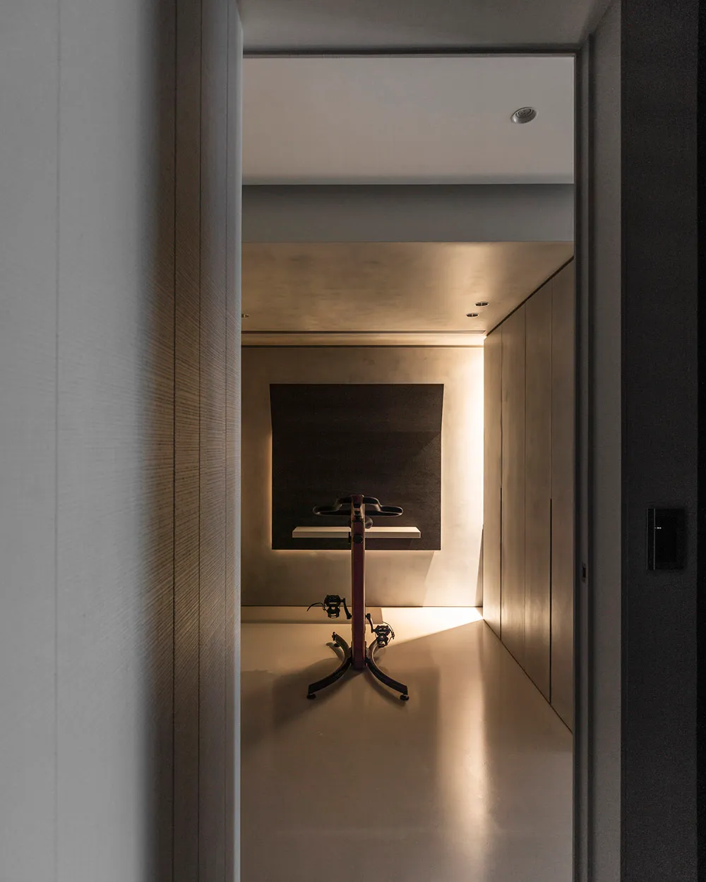 Modern home office designed with minimalist style, featuring a metal and concrete desk.