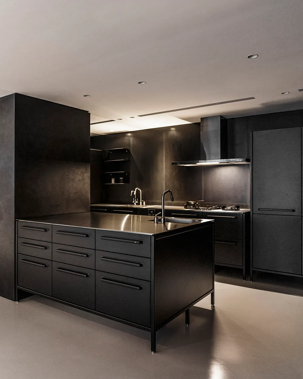 Modern black metallic kitchen featuring sleek design and stainless steel fixtures.