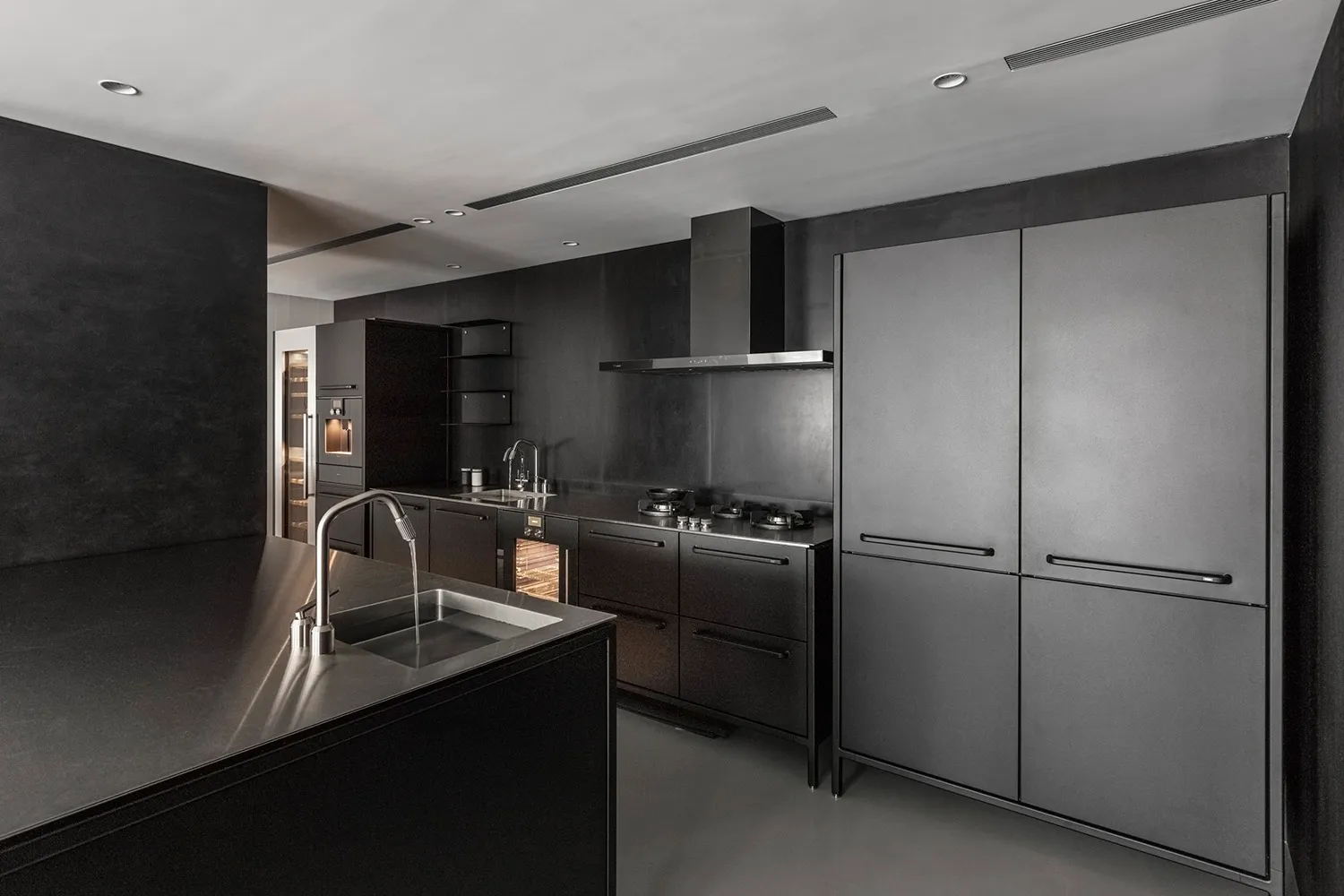 Modern kitchen with metallic surfaces and sleek design features.