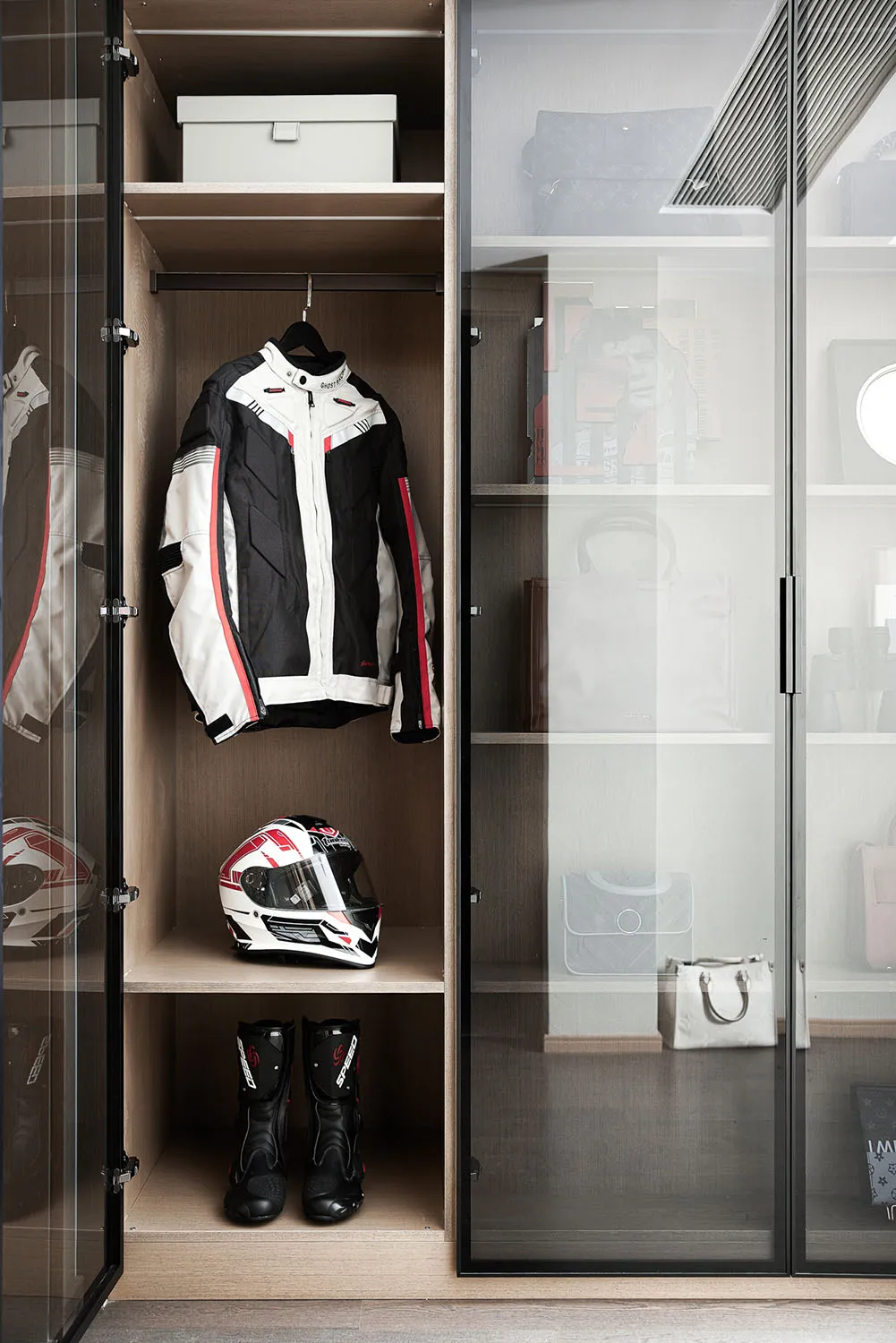 Modern minimalist shelving unit displaying clothing and accessories.