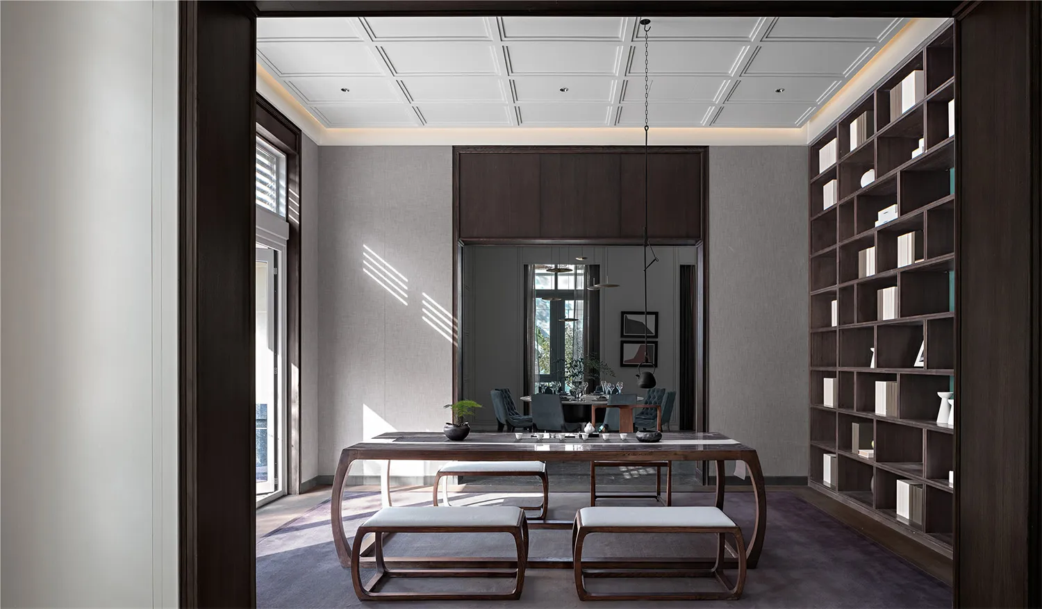 Modern living room with wooden furniture and a large bookshelf.