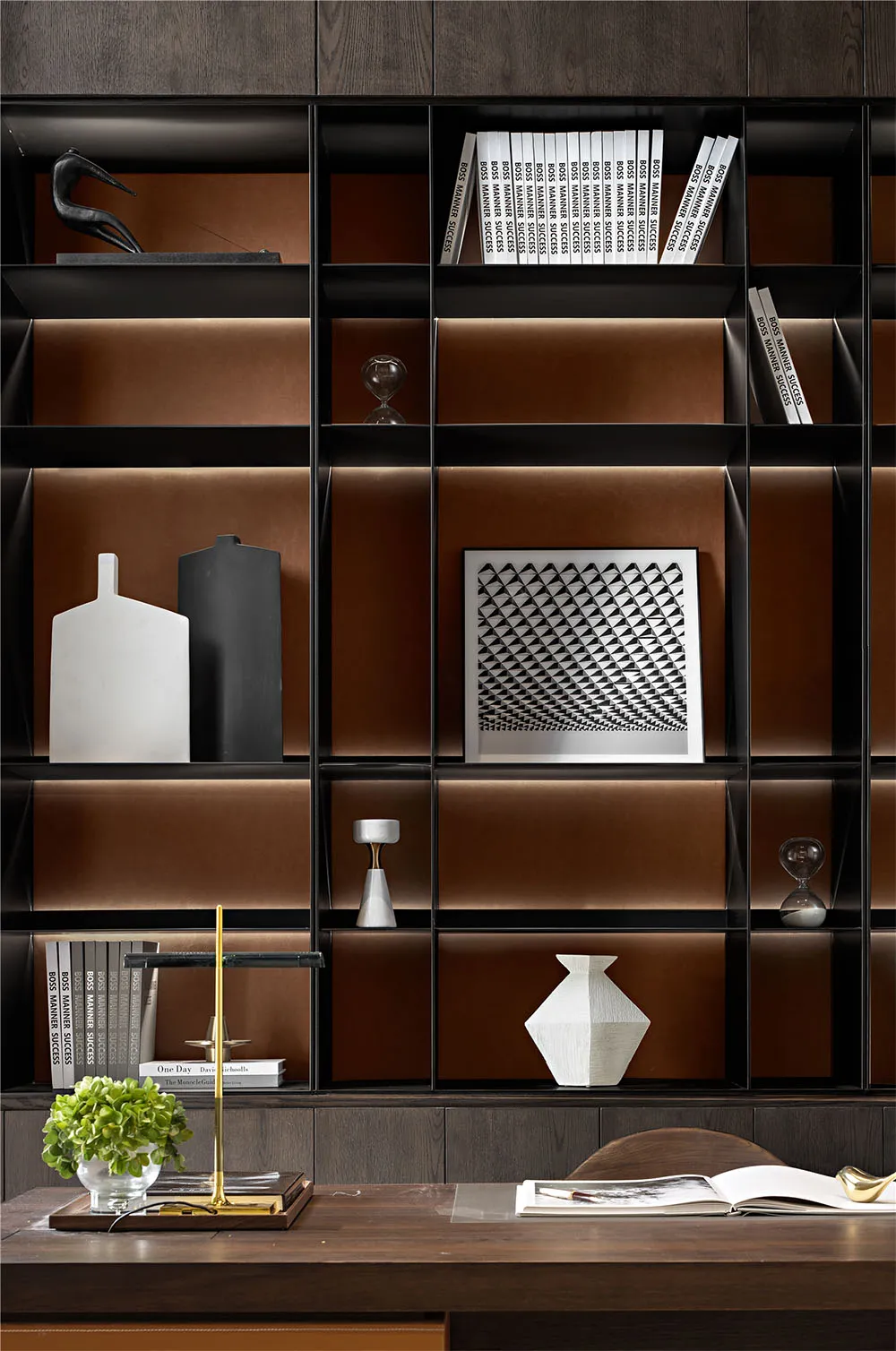 A modern minimalist bookshelf with black and white decorations and books.