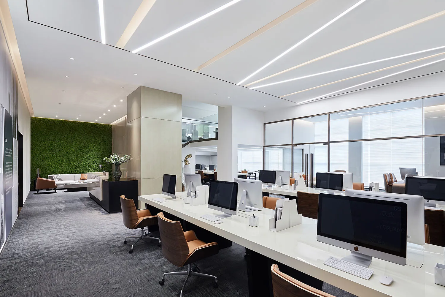 Modern office space featuring sleek, minimalist design with concrete floor and white accents.