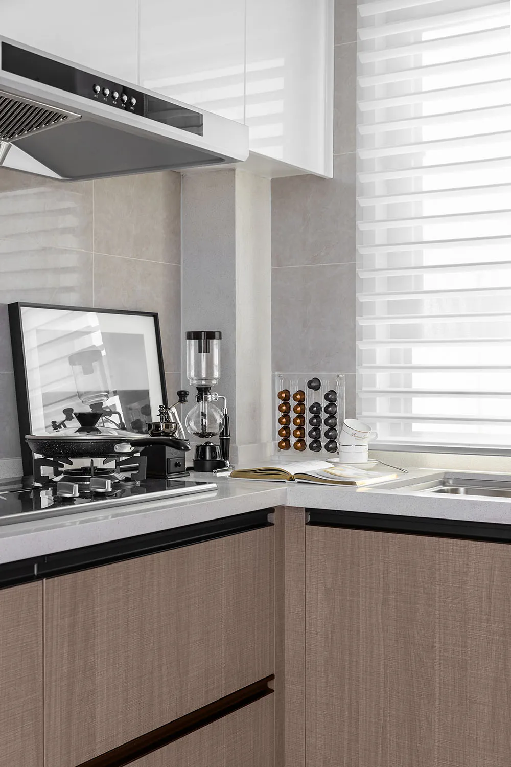 Modern minimalist kitchen featuring granite countertops and wooden texture cabinets.