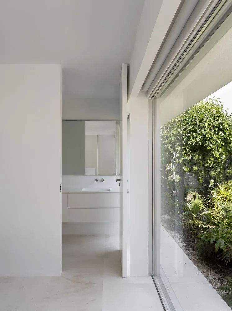 Modern minimalist bathroom with concrete walls and a clean, uncluttered design.