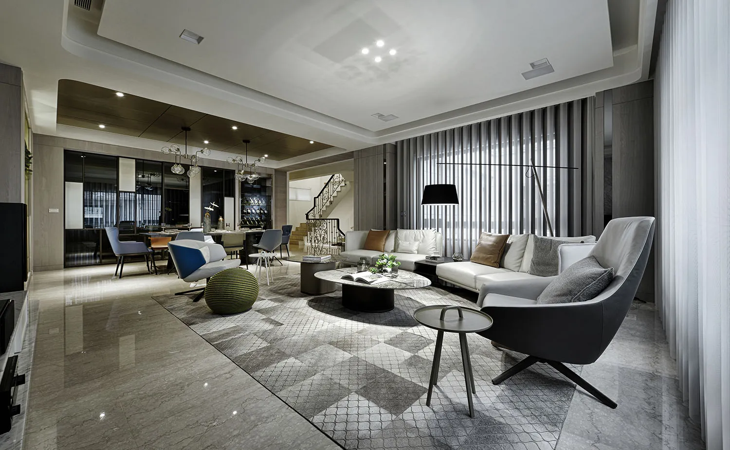 A contemporary living room featuring a spacious marble floor, a comfortable sofa, and modern furniture.