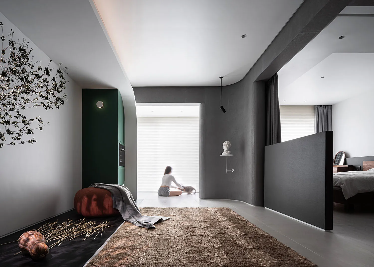 A modern minimalist residential interior featuring concrete, wood, and glass materials.