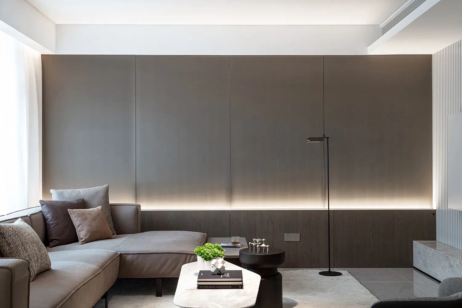 Modern minimalist living room featuring metal panels and contemporary furniture, designed for comfort and style.
