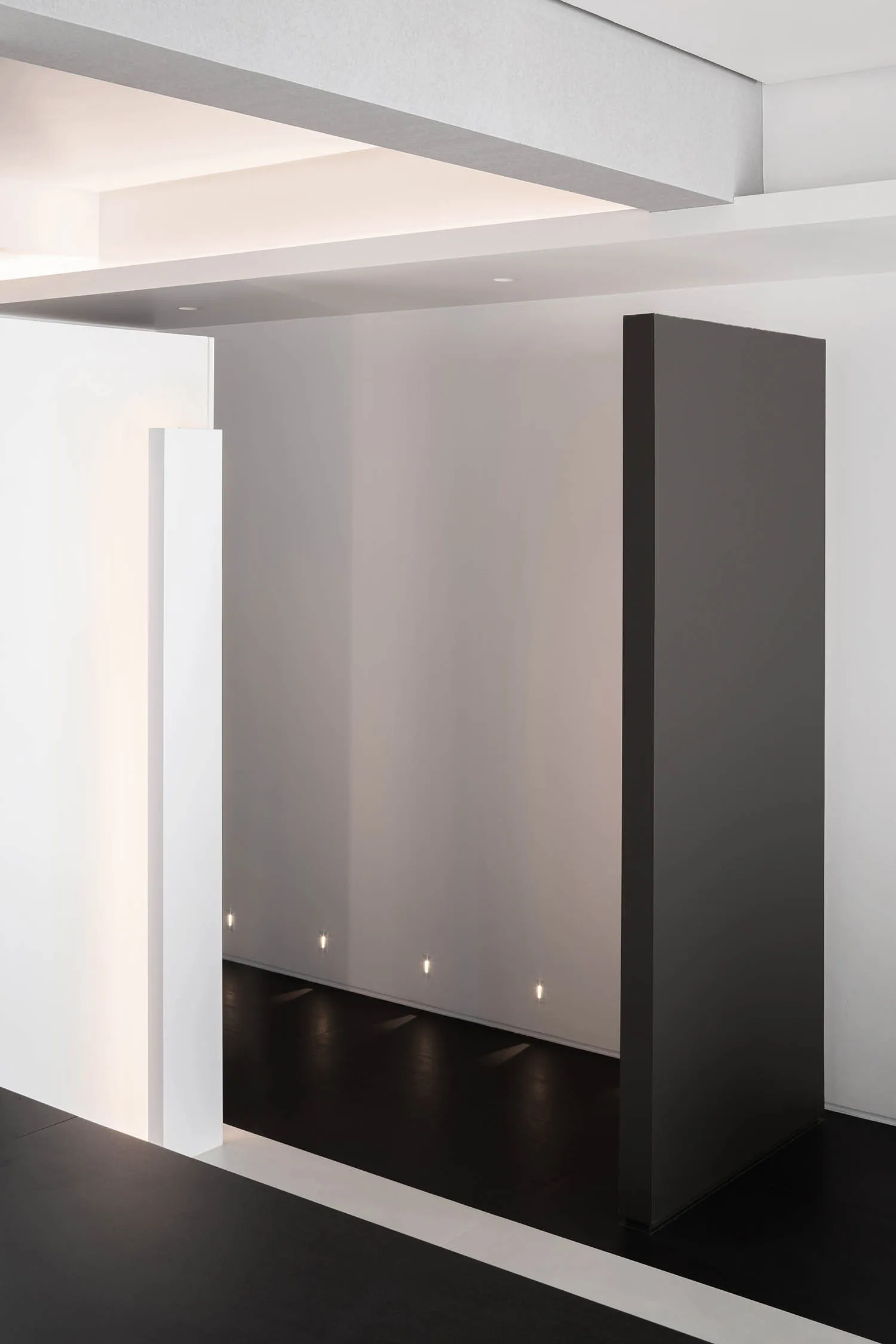 A minimalist office space featuring metallic surfaces and a clean, geometric design.