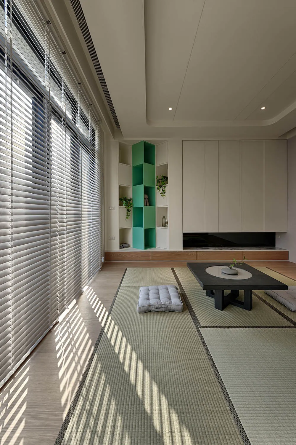 A modern living room with tatami flooring, featuring minimalist furniture and sleek, contemporary design.