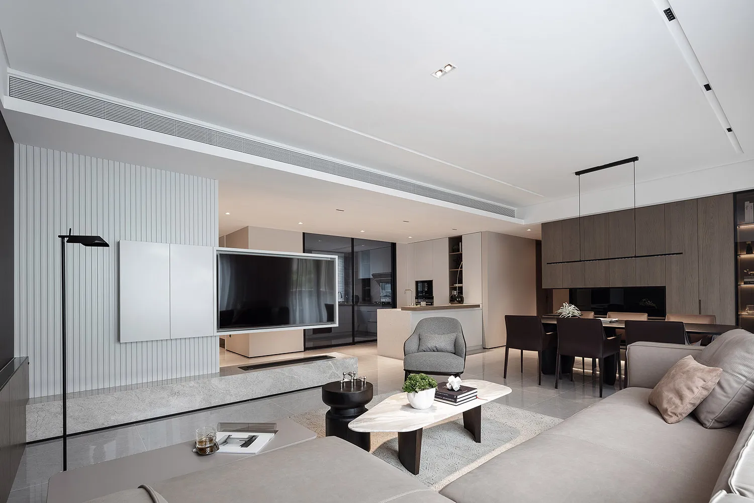 Contemporary living room with modern furniture, marble accents, and neutral color palette.