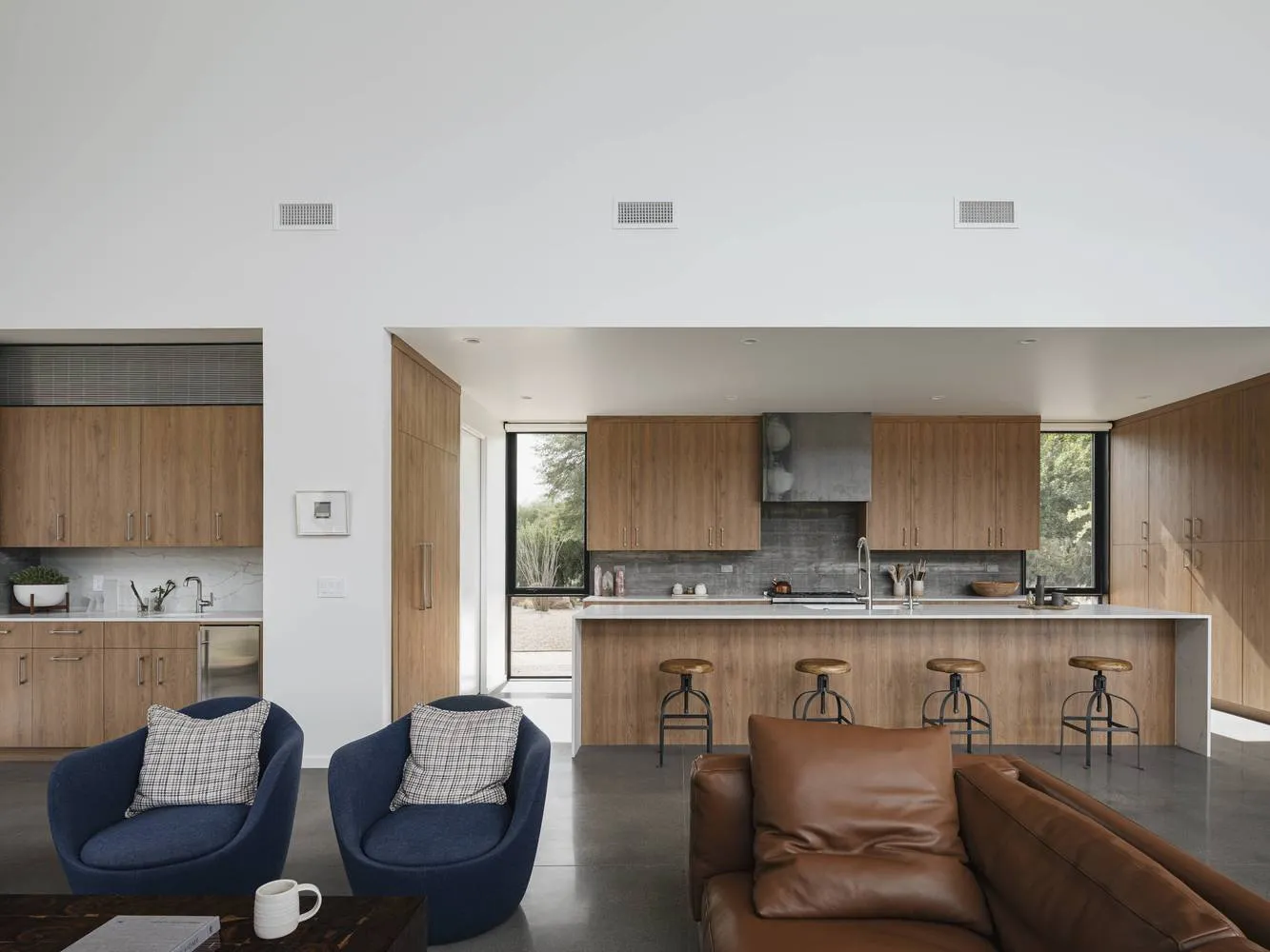 A modern residential interior featuring wooden cabinets and a kitchen island.