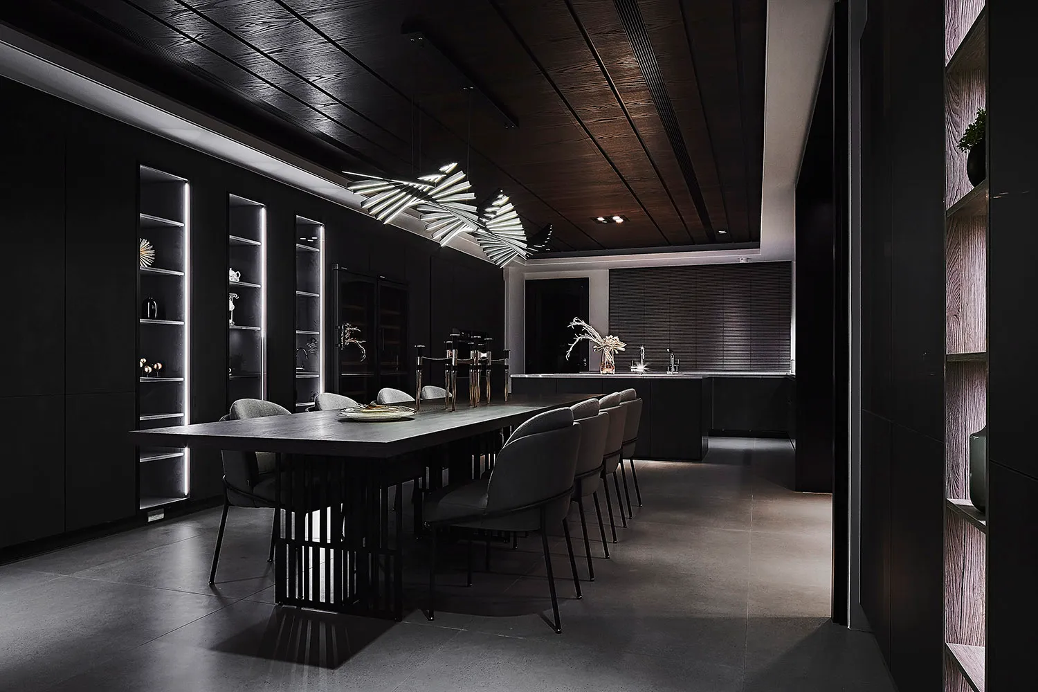Modern black dining room featuring metallic furniture and a sleek design.