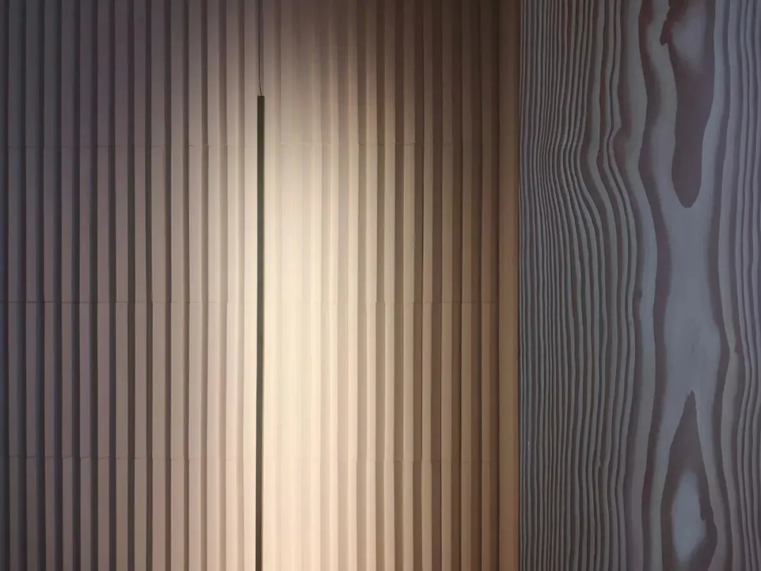 A modern interior design featuring neutral textured materials and lighting effects.