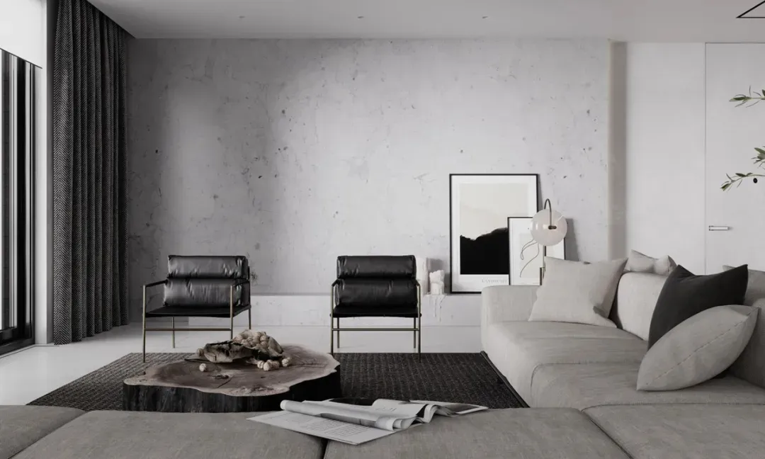 A modern living room with minimalist design, featuring black leather armchairs, a wooden coffee table, a large grey sofa, and