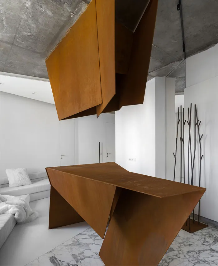 A modern living room with a unique, rust-colored metal table and cabinet, set against a white background and marble floor.