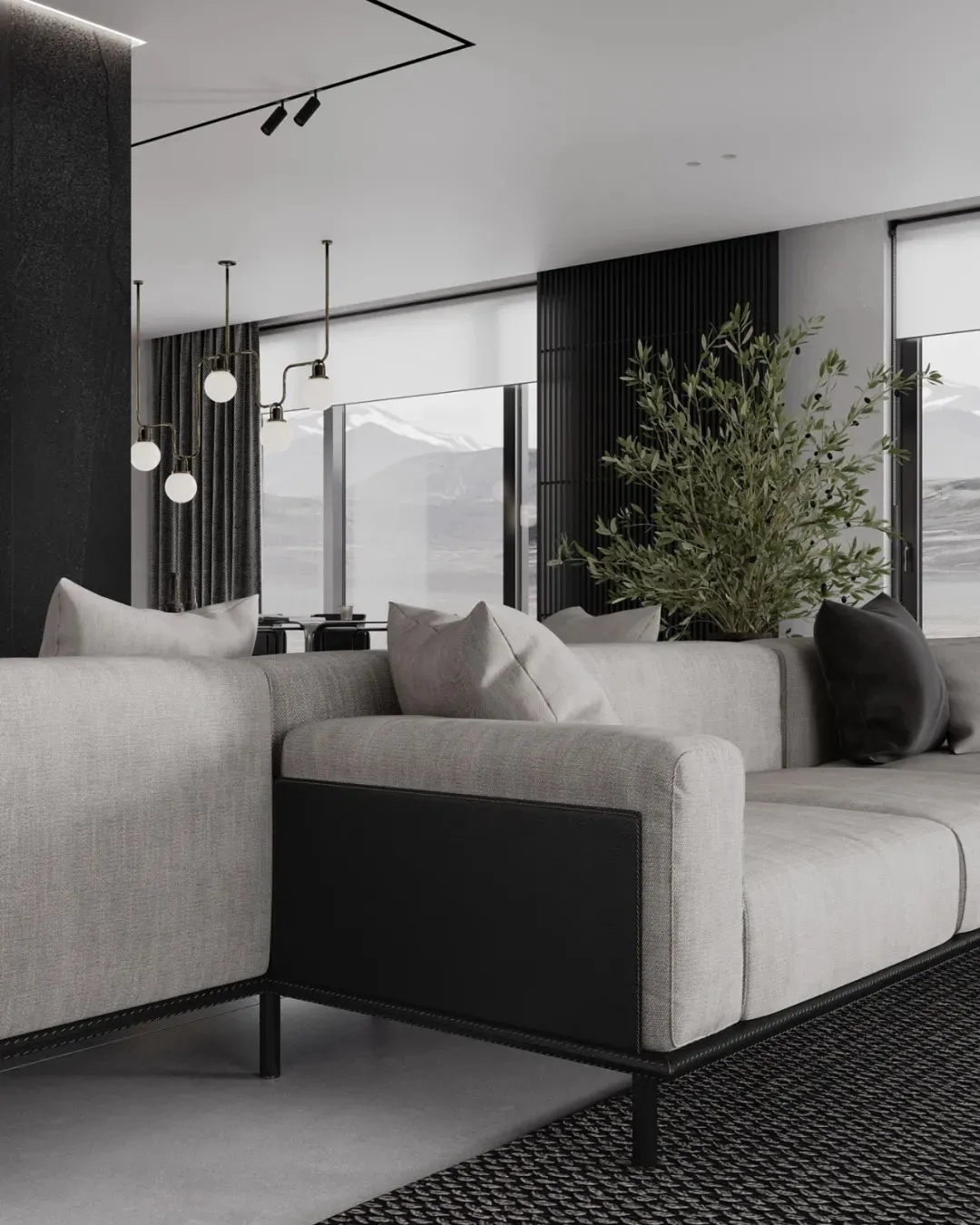 Modern living room featuring a sectional sofa upholstered in fabric and leather, with minimalist decor and large windows.