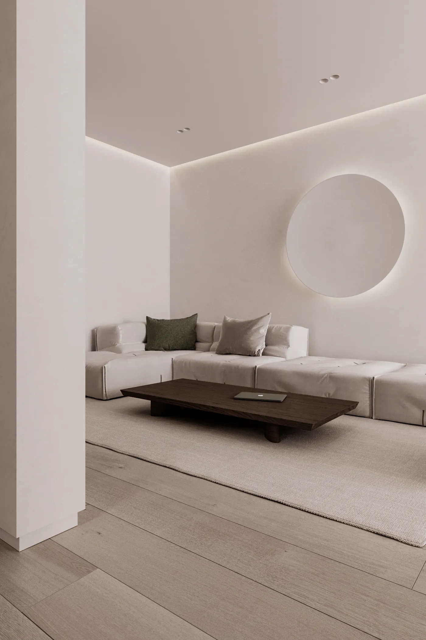 Minimalist living room with a neutral color scheme, featuring a low coffee table and a modern sofa.