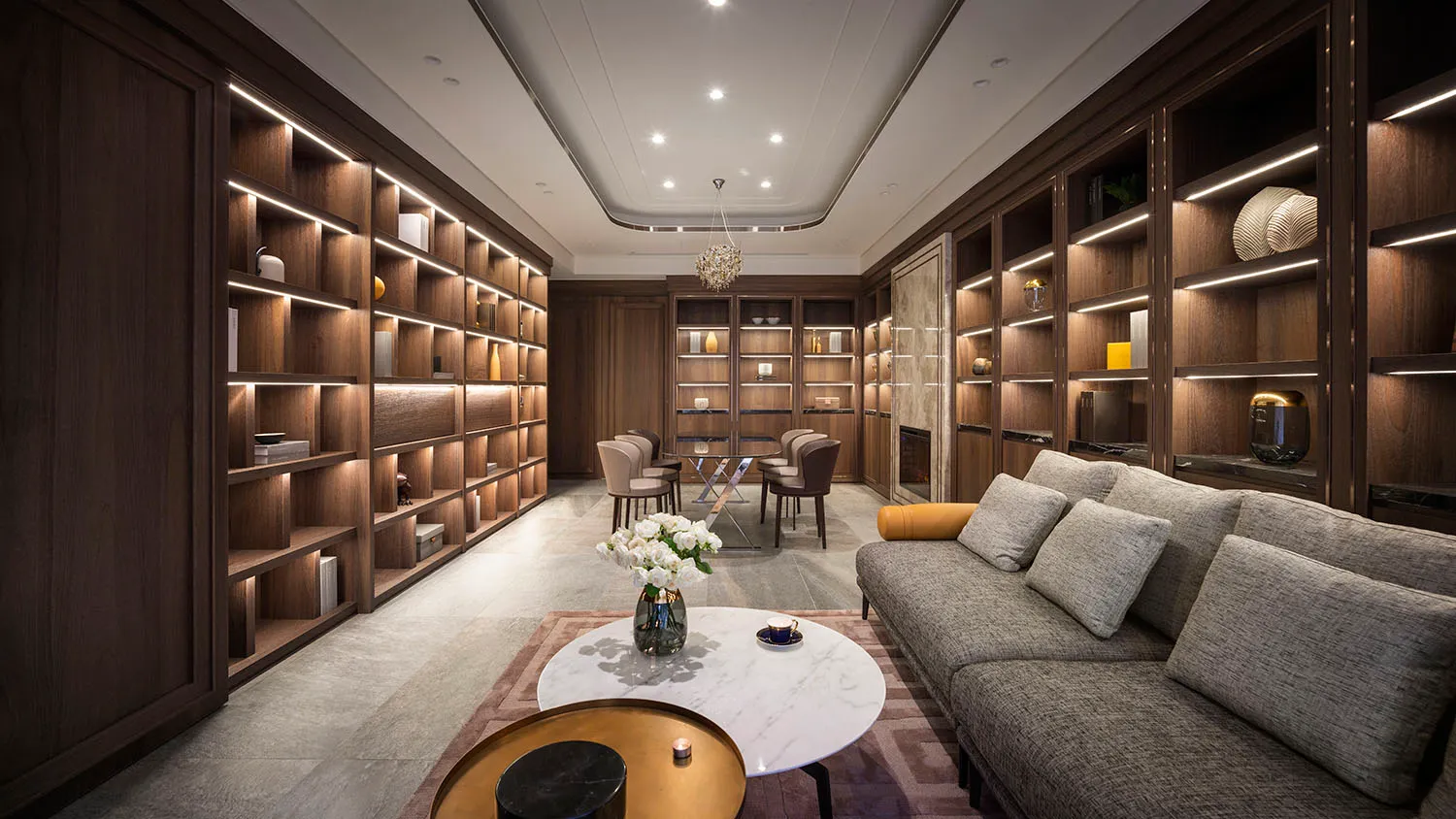 A modern living room with a marble coffee table, wooden shelves, and a leather sofa.