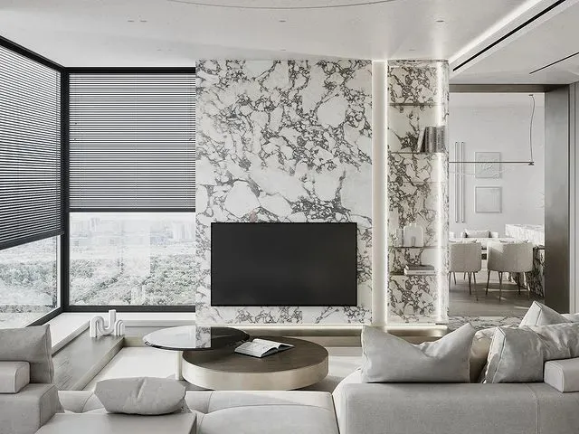 A minimalist living room with marble and glass elements.