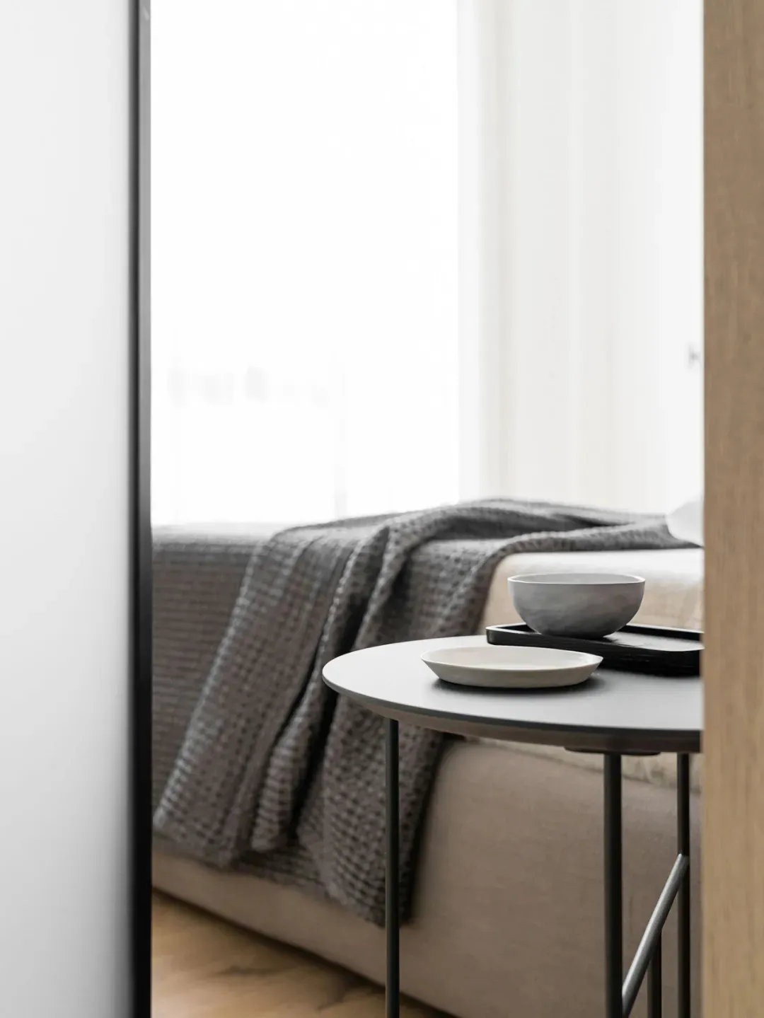 A minimalist living space with fabric and metal elements.