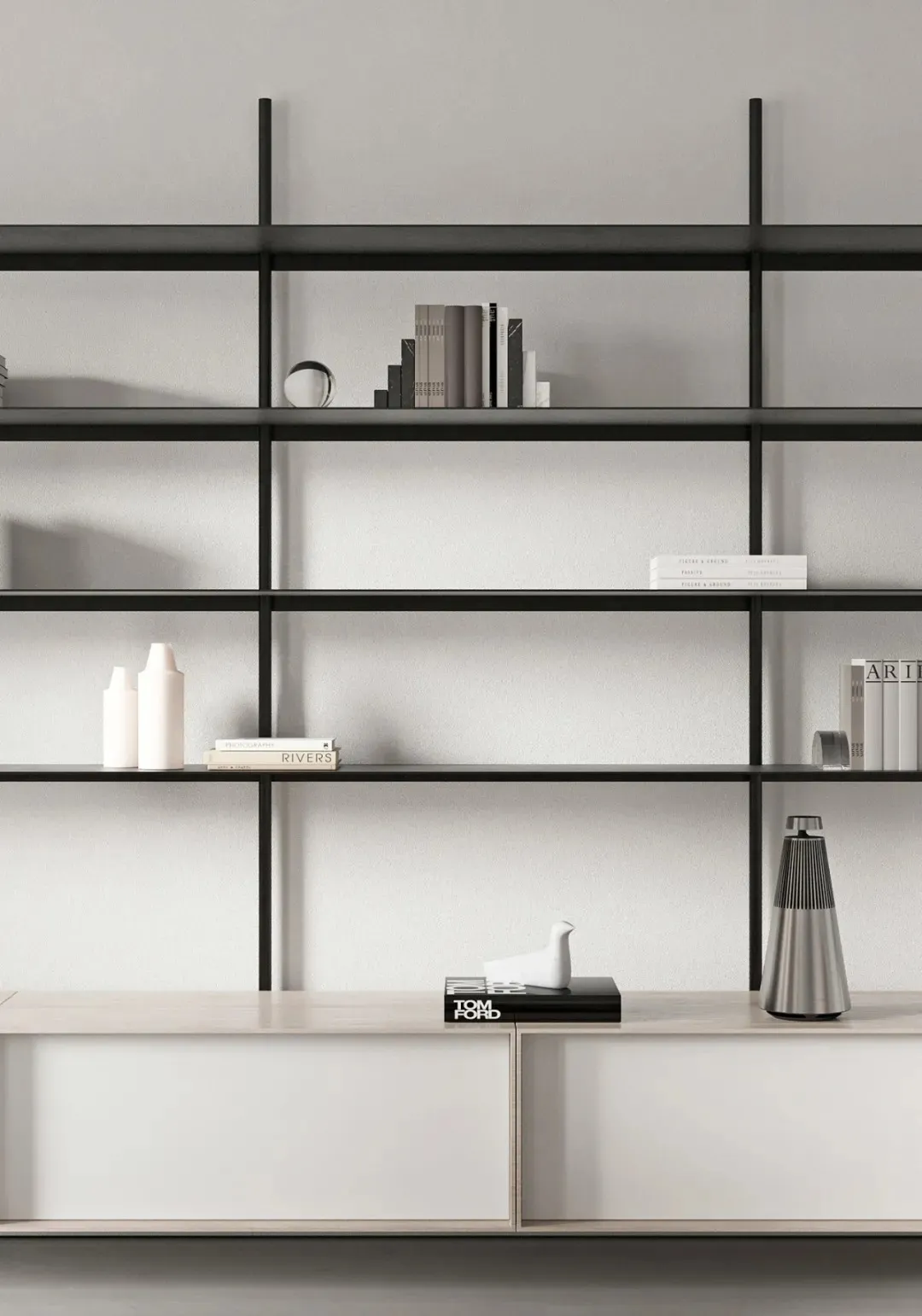 A minimalist metal shelf with books and decorative objects.