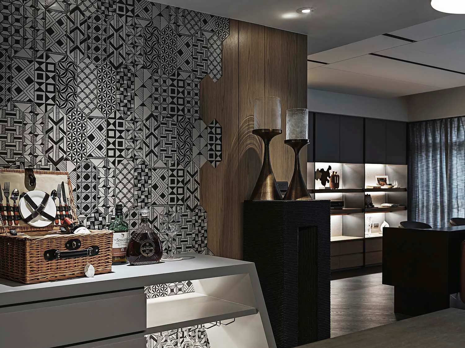 A modern industrial living room featuring a pedestal with a patterned wall, wooden and concrete elements, and a dining area w