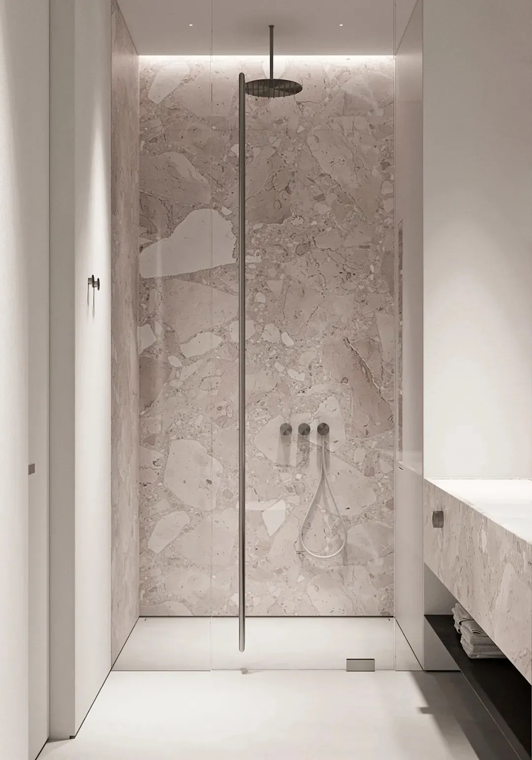 Modern minimalist bathroom with a luxurious marble shower stall.