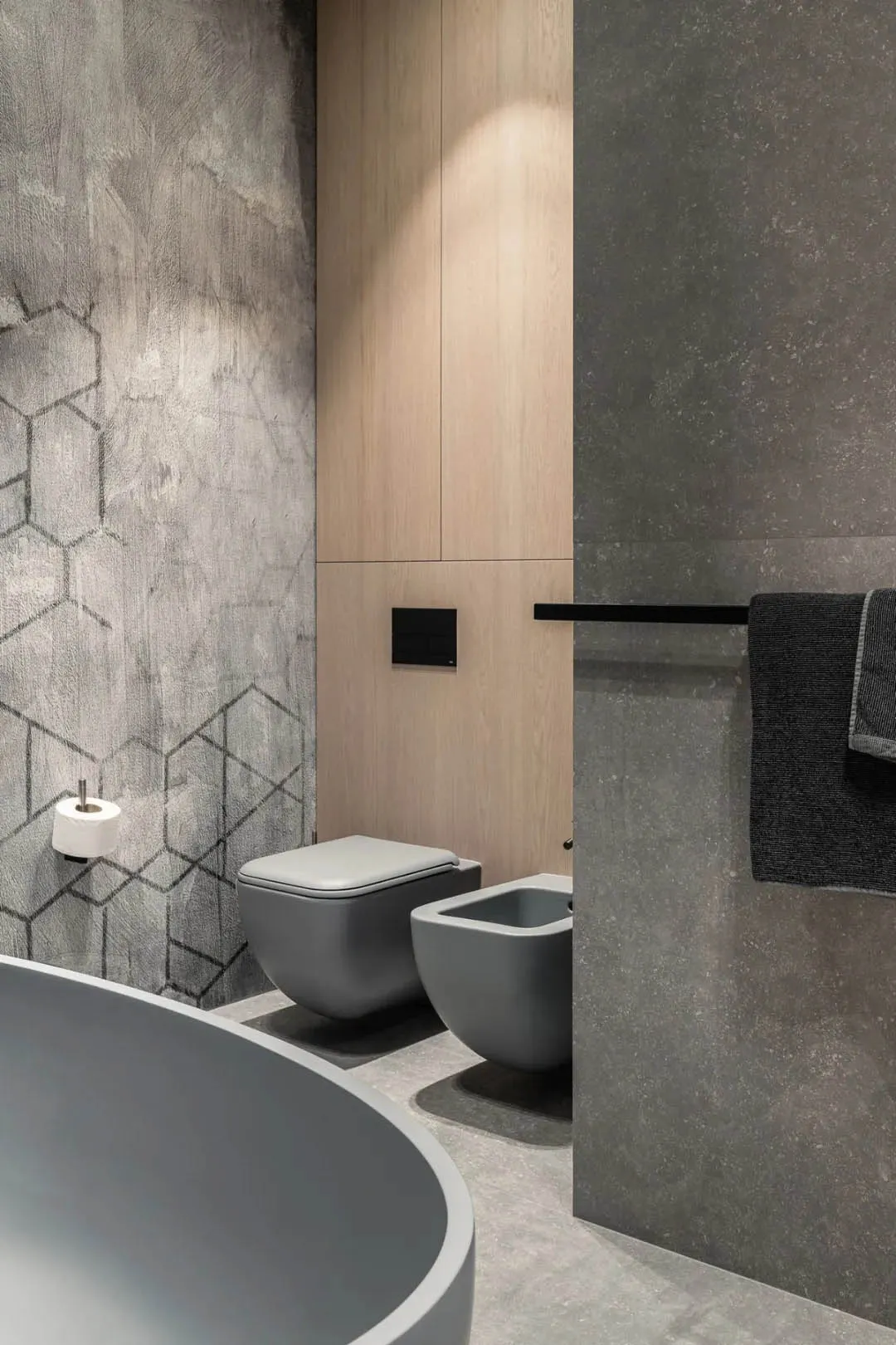 Modern bathroom featuring concrete and wood materials with a metallic finish.