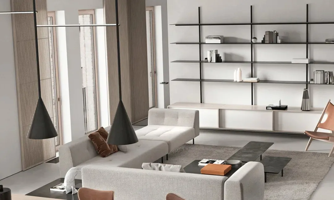 A modern living room with neutral-toned furniture, minimalist decor, and a large window with natural light.