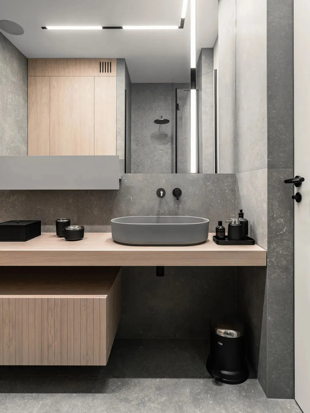 Modern minimalist bathroom featuring a concrete sink and minimalist decor.