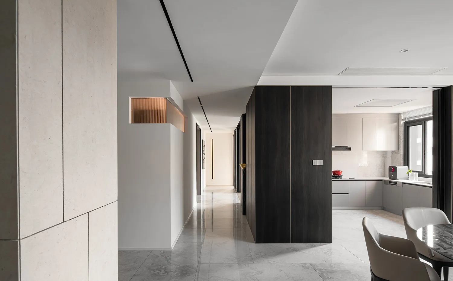 Modern residential kitchen featuring concrete walls and matte black wood