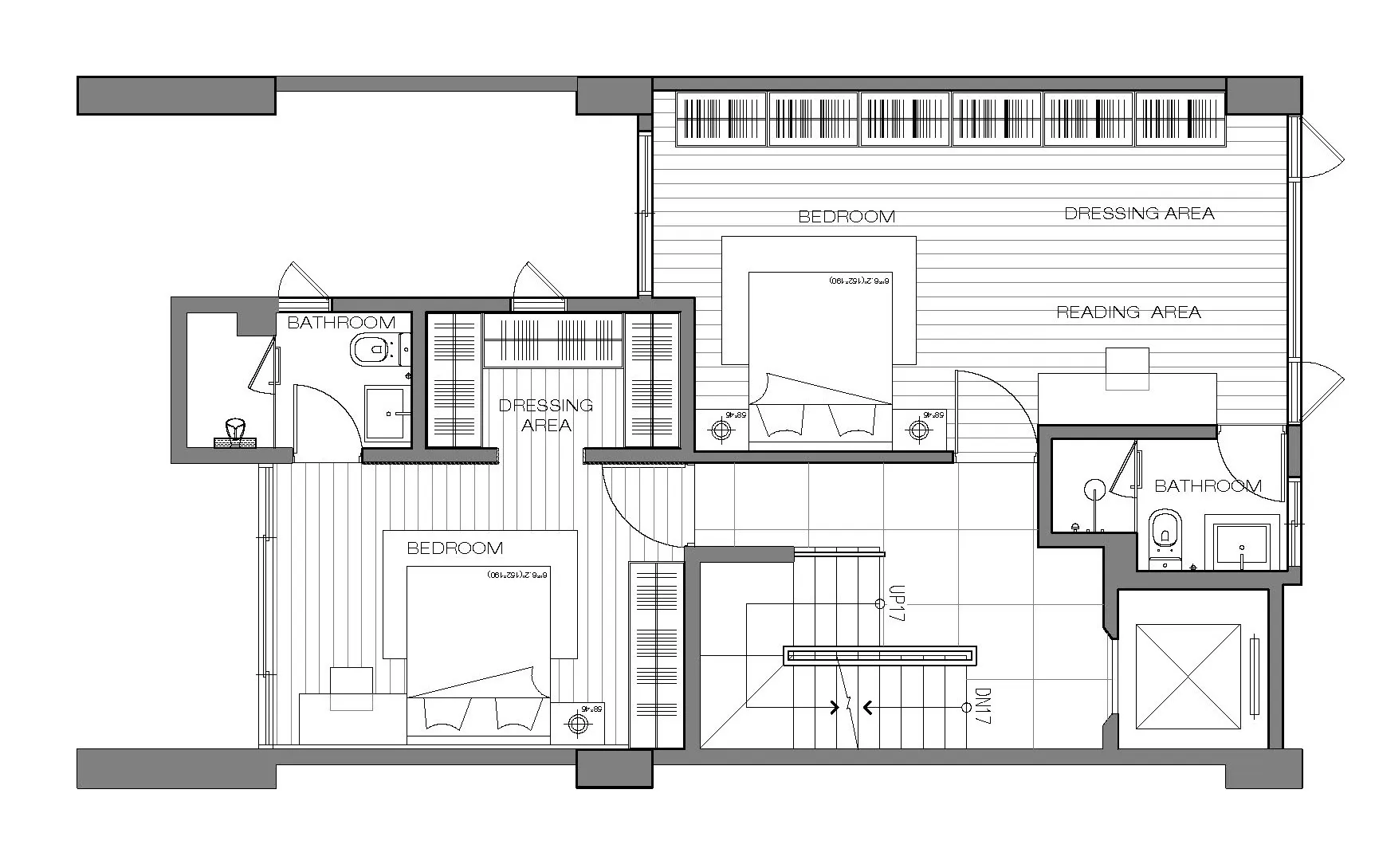 A detailed 2D architectural drawing of a modern studio apartment, featuring a bedroom, bathroom, and dressing area.