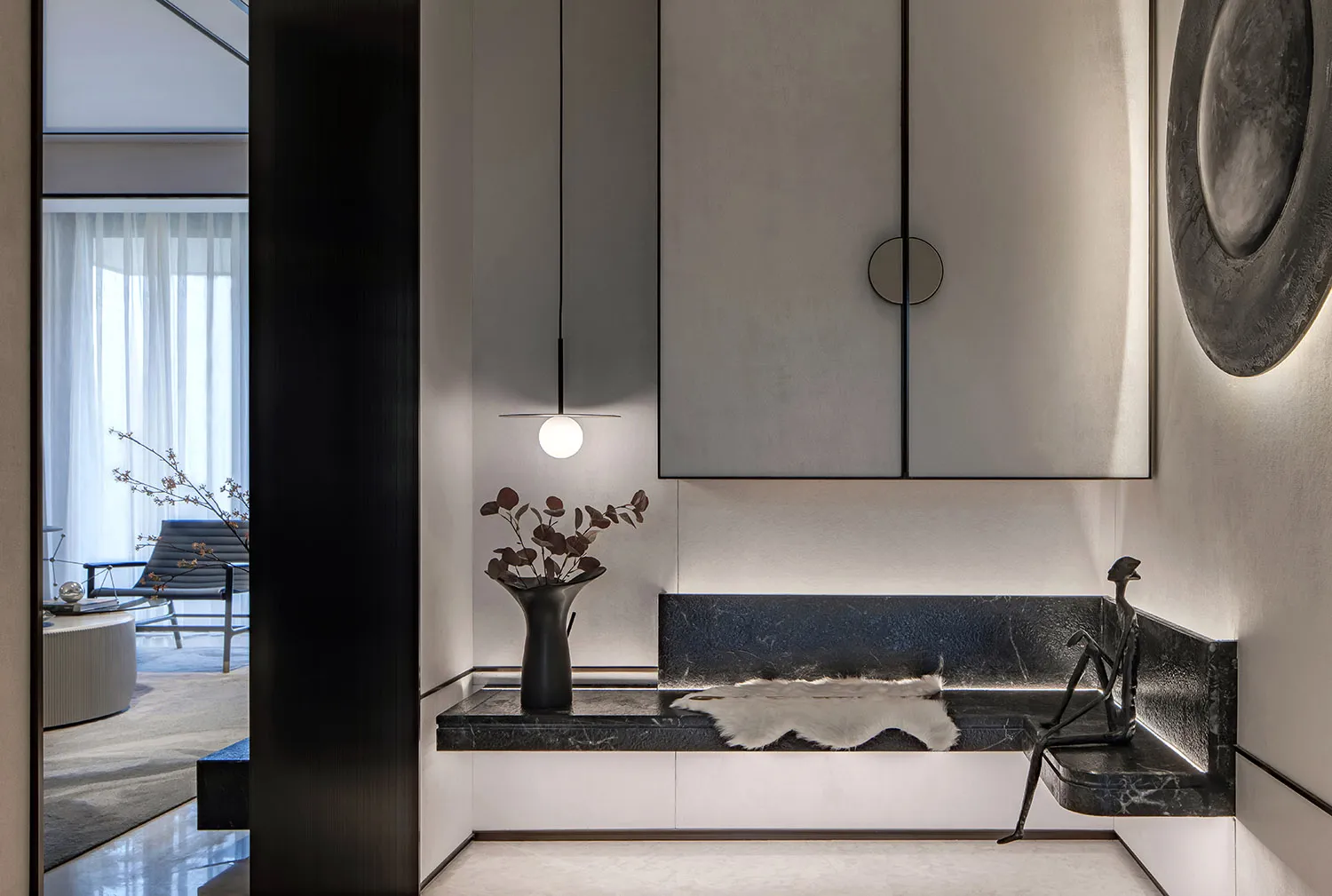 A modern lounge area with marble, concrete, and leather materials, featuring a minimalist design with a sleek, sophisticated
