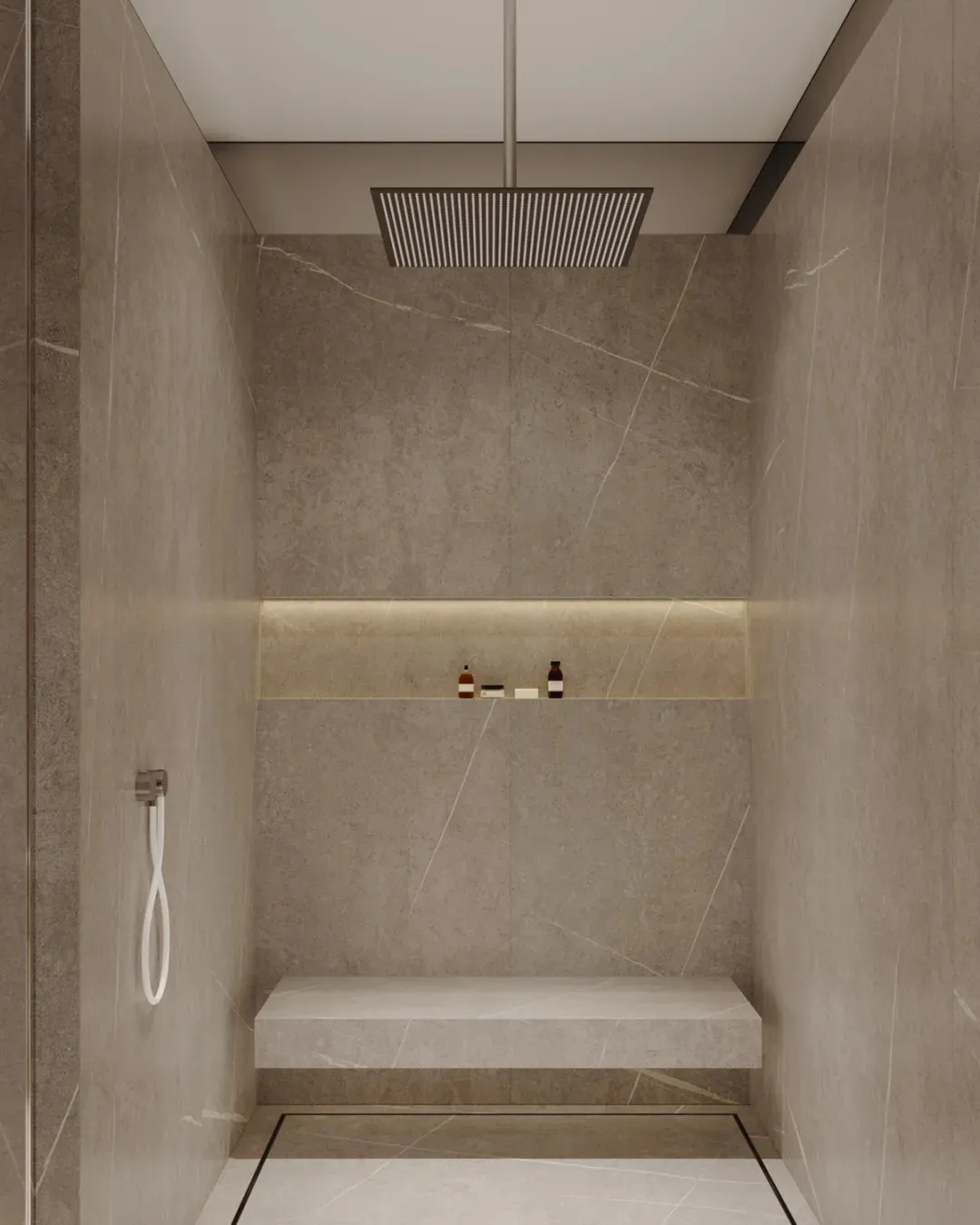 Modern, minimalist bathroom shower with marble walls and a built-in bench.