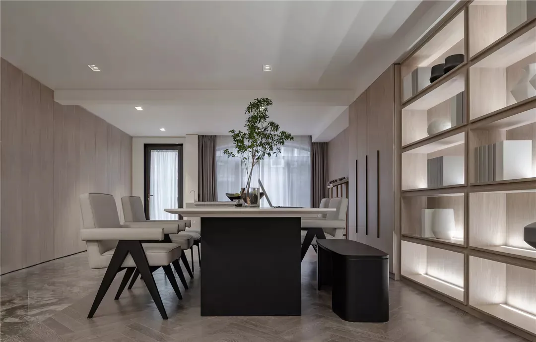 Modern dining room featuring a long wooden table surrounded by six upholstered chairs with contemporary black legs, white cur