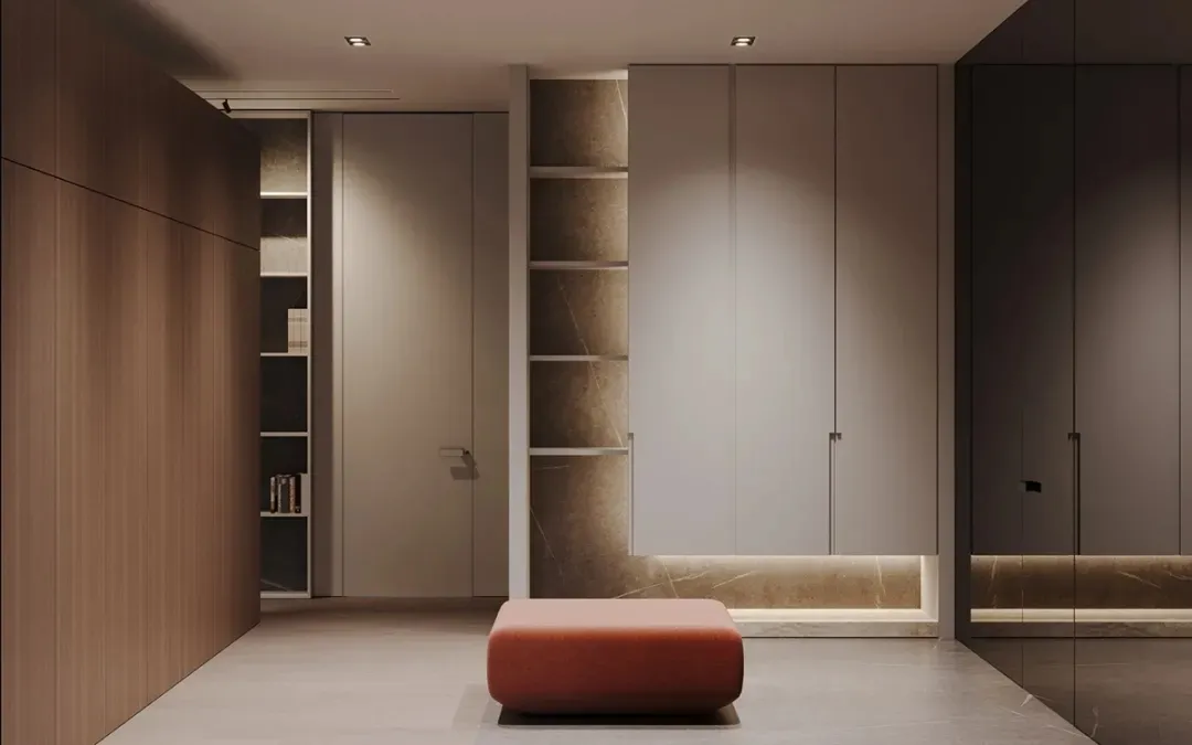 A minimalist clothing display with a red ottoman and open shelving units.