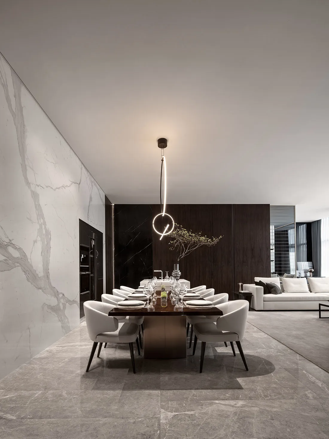 Modern dining room with marble table and chairs, minimalist decor, and sleek design.