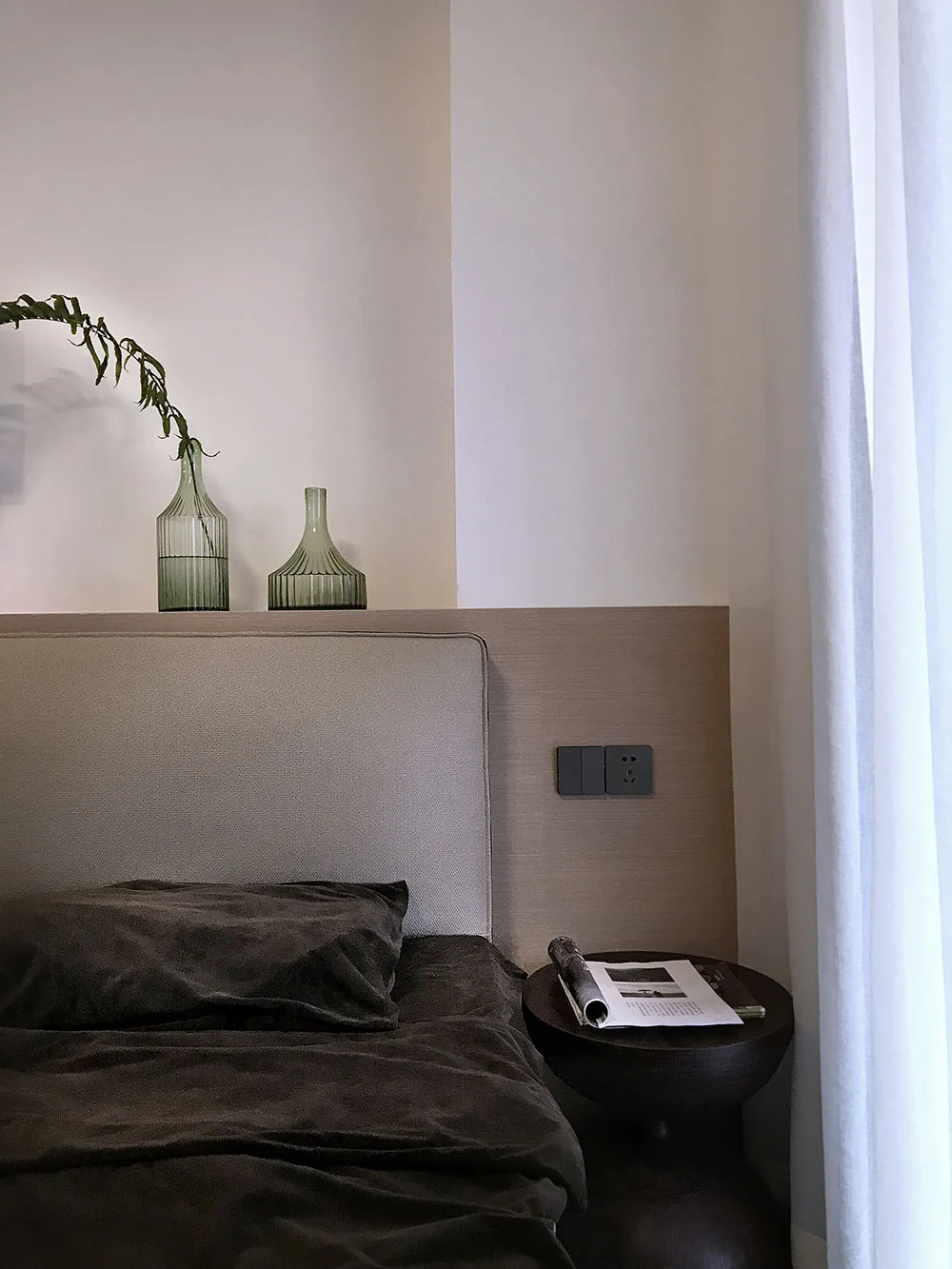 Modern minimalist bedroom with comfortable furniture and elegant decor.