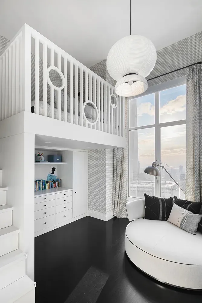 A modern bathroom featuring white concrete walls and floors, with a circular white bathtub and a white vanity cabinet.