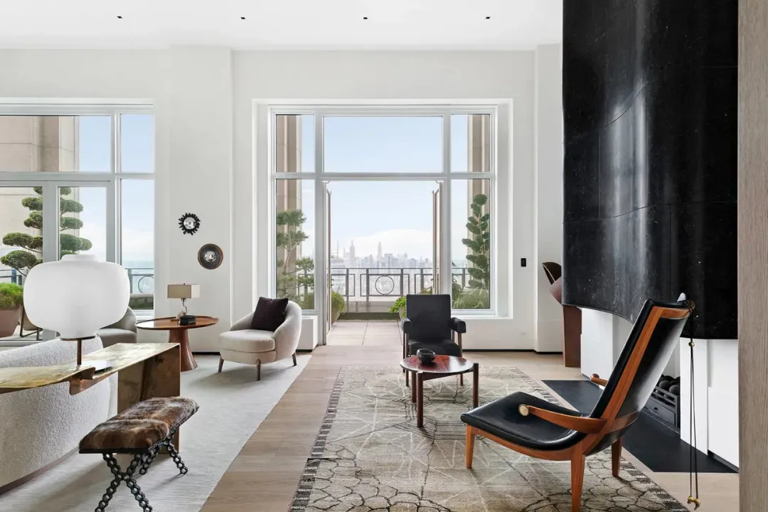 Modern living room featuring marble, leather, and glass materials.