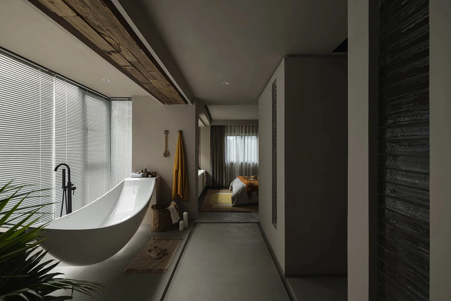 Modern minimalist bathroom with a freestanding bathtub, concrete walls, and yellow accents.