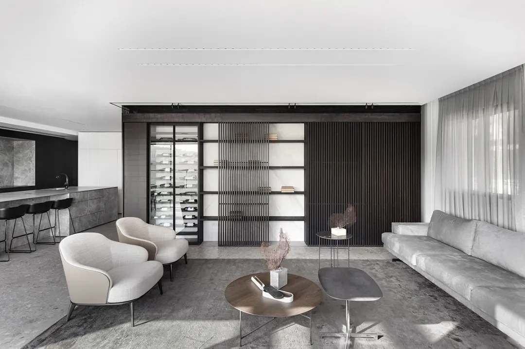 Modern living room with concrete, wood, and marble materials