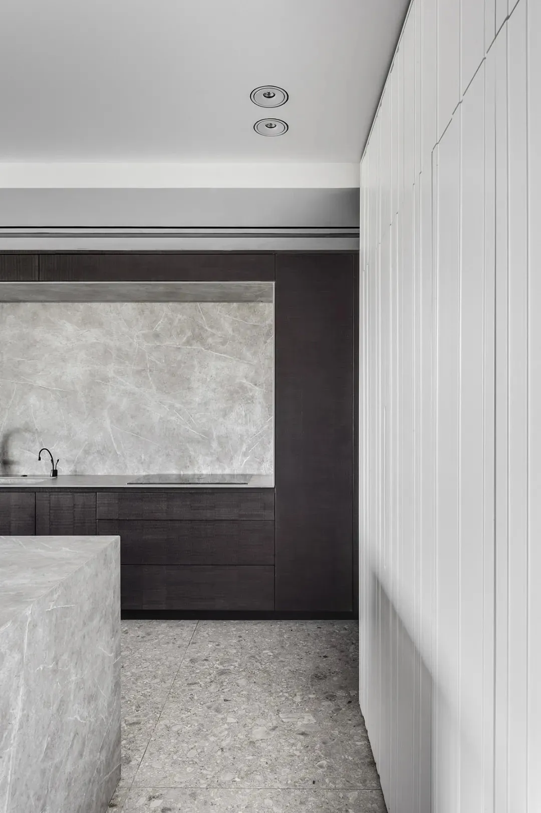Modern kitchen featuring marble countertops and floor tiles