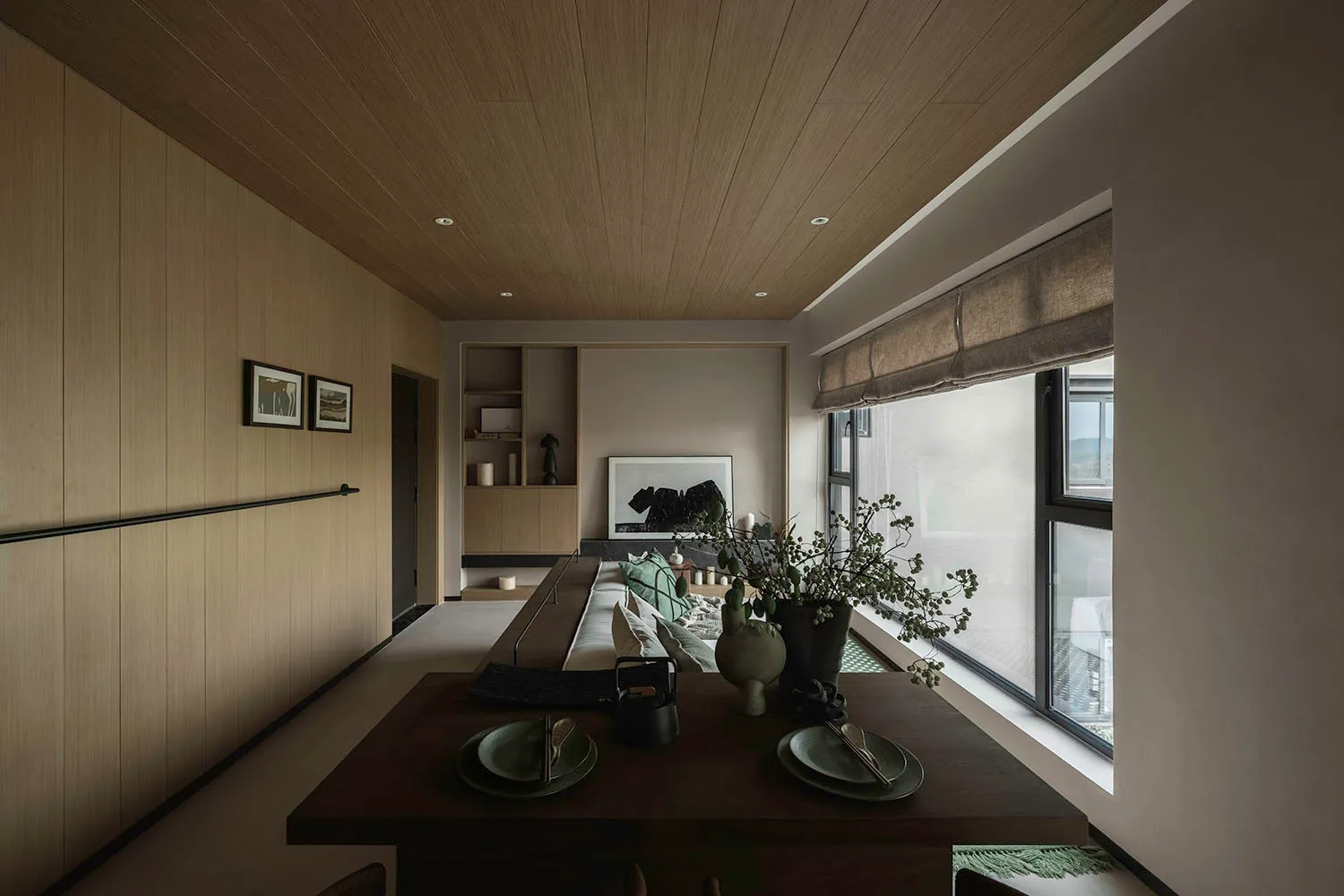 Modern residential dining area featuring a wooden table, fabric seating, and glass elements.