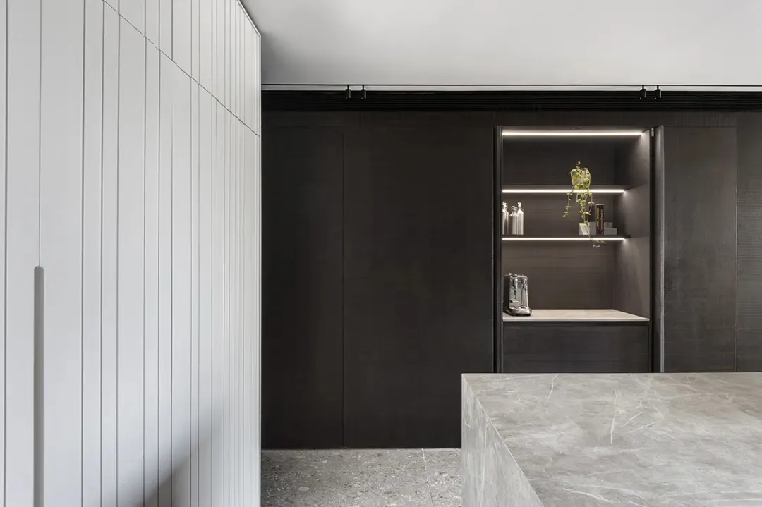 Modern residential kitchen featuring stone and metal materials.