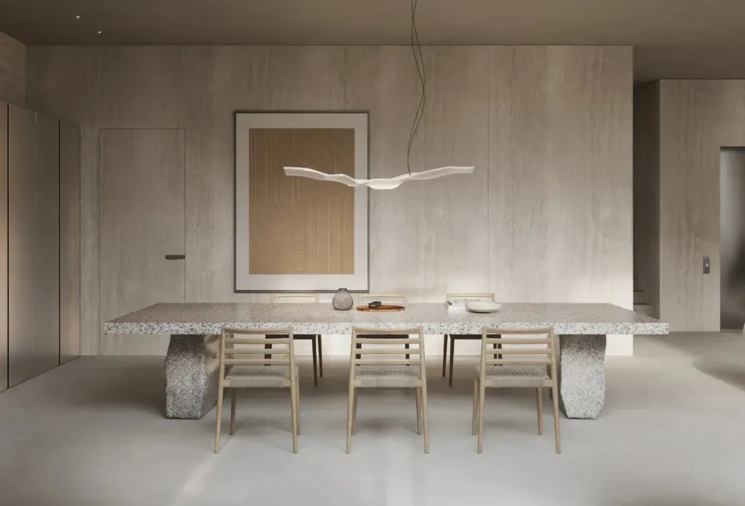 Modern dining room with a long, rectangular terrazzo-topped dining table surrounded by wooden chairs and a minimalist pendant
