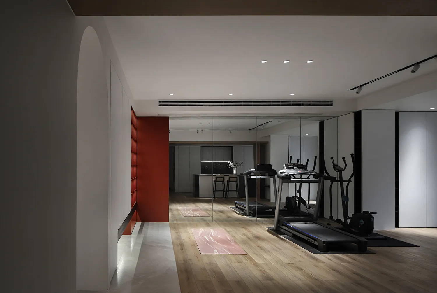 Modern home office and gym with wooden flooring and glass walls